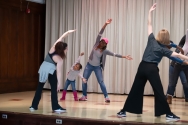 students and parents stretching in dance class