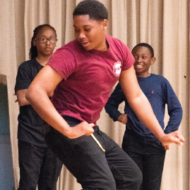 Male student dancing at One World Middle School performance